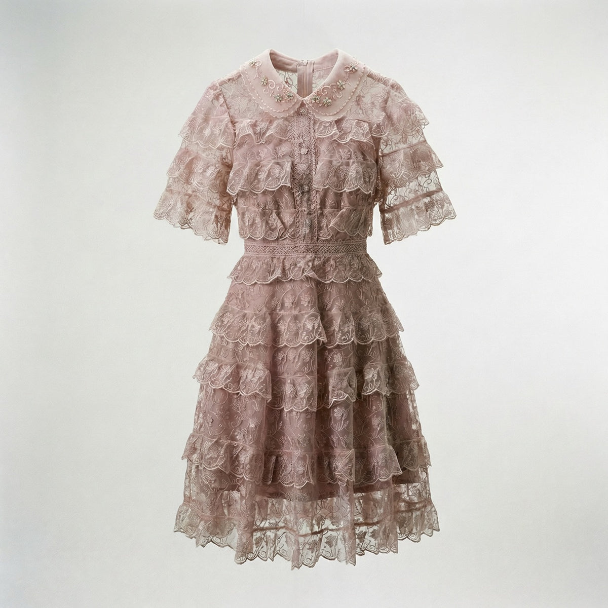 Adara tiered lace mini dress in dusty rose featuring floral lace and beaded collar.