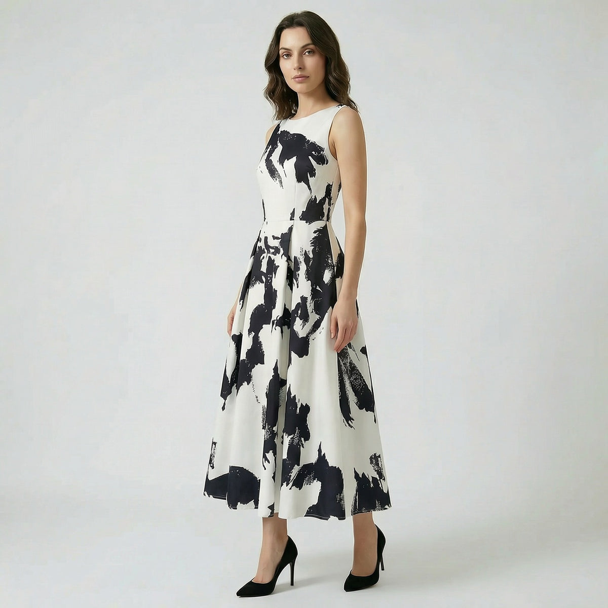 Afaf sleeveless midi-maxi dress in vibrant yellow and pink floral print featuring a pleated skirt and side pockets.