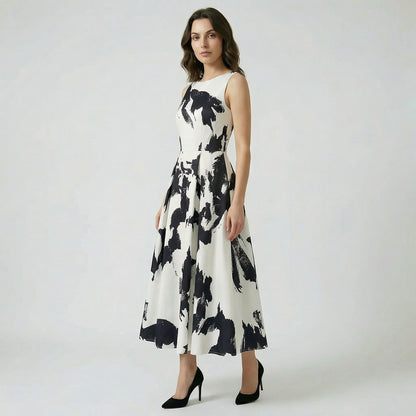 Afaf sleeveless midi-maxi dress in vibrant yellow and pink floral print featuring a pleated skirt and side pockets.
