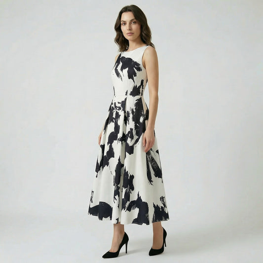 Afaf sleeveless midi-maxi dress in vibrant yellow and pink floral print featuring a pleated skirt and side pockets.