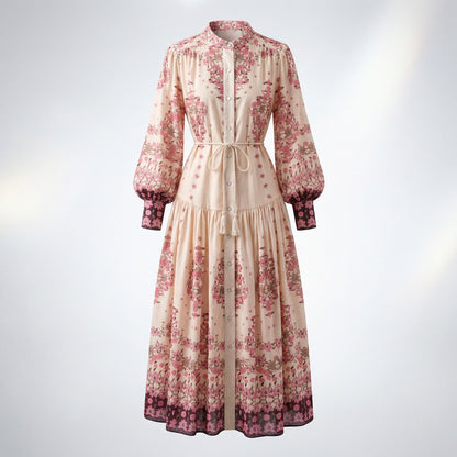 Front view of the Barbara floral maxi dress in cream and pink with puff sleeves and a braided tassel belt