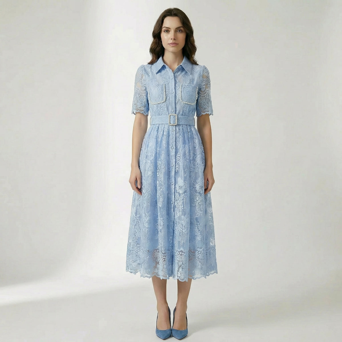 Carol floral lace midi dress in light blue, ivory, and pink featuring pearl-trimmed pockets and a matching buckle belt on a flat lay display.