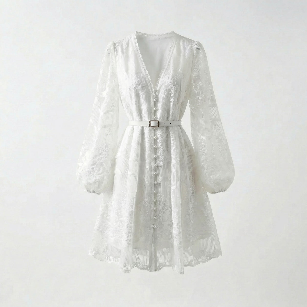 White floral lace mini dress with long puff sleeves and pearl buttons on a flat lay background