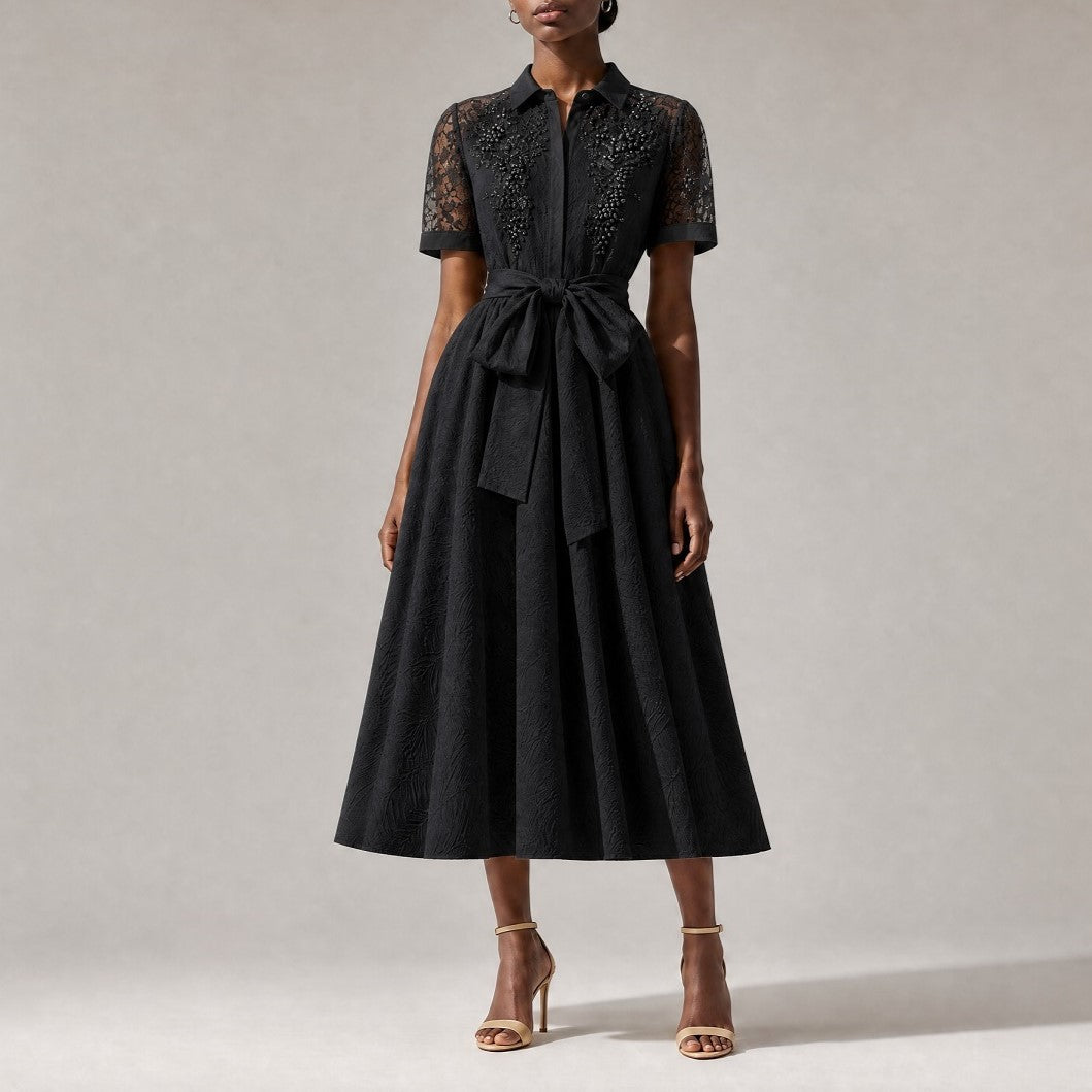 classic black Marta elegant evening midi dress, showcasing its flowing A-line skirt and textured fabric pattern.Marta dress collar and upper chest, showing intricate sheer lace paneling and luxurious faux pearl floral embroidery.