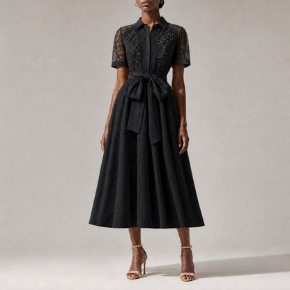 classic black Marta elegant evening midi dress, showcasing its flowing A-line skirt and textured fabric pattern.Marta dress collar and upper chest, showing intricate sheer lace paneling and luxurious faux pearl floral embroidery.