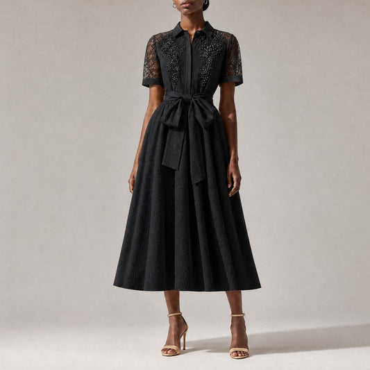 classic black Marta elegant evening midi dress, showcasing its flowing A-line skirt and textured fabric pattern.Marta dress collar and upper chest, showing intricate sheer lace paneling and luxurious faux pearl floral embroidery.