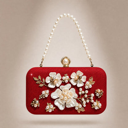 Beige textured glitter Gabia box clutch featuring intricate pearl flowers, rhinestone accents, and a large top pearl clasp closure. Red Gabia clutch evening bag with 3D white floral embellishments, gold leaves, and a faux pearl beaded handle.