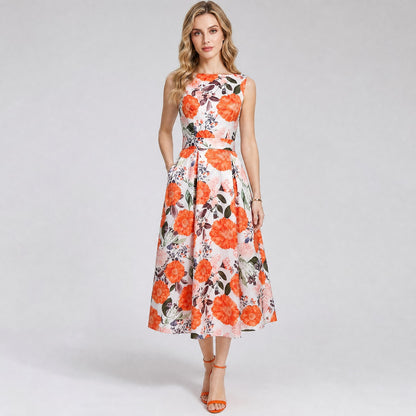Gabia sleeveless midi dress in a vibrant pink and white floral pattern with a boat neck and pleated skirt midi dress featuring a rich orange floral and countrystyle leaf pattern on white fabric