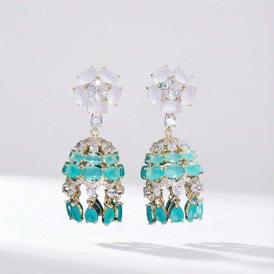 Pair of Hanah 4.6cm drop earrings featuring a frosted white flower stud and tiered teal-colored cubic zirconia dangles on a gold-tone base.