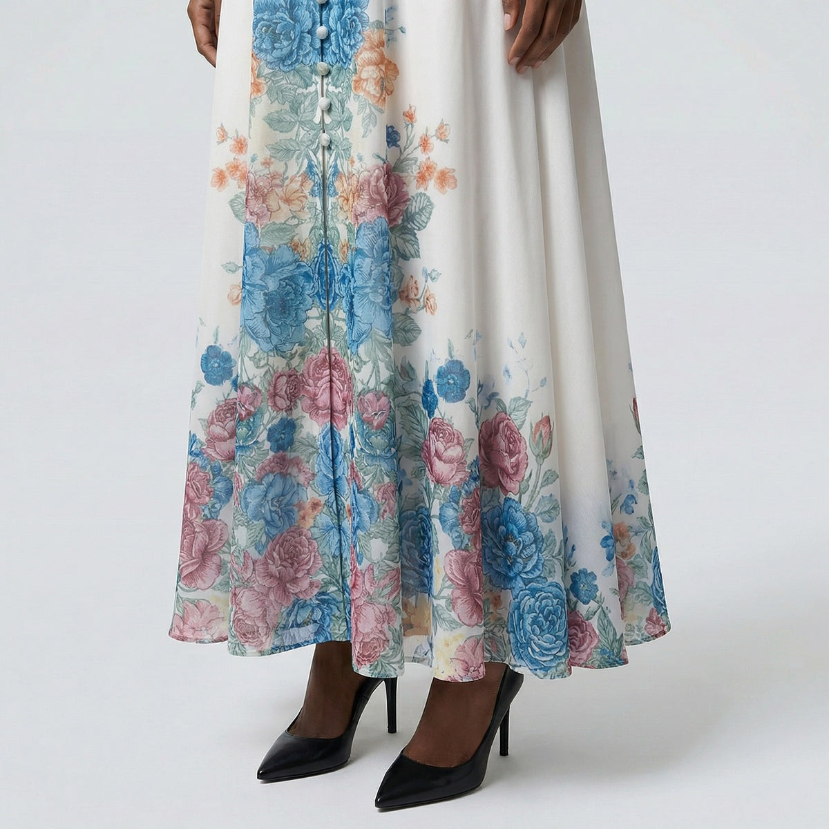 The Heba maxi dress in a 141 cm length featuring a long-sleeved ribbed knit bodice and a dramatic side-pleated accordion skirt with a matching waist belt.