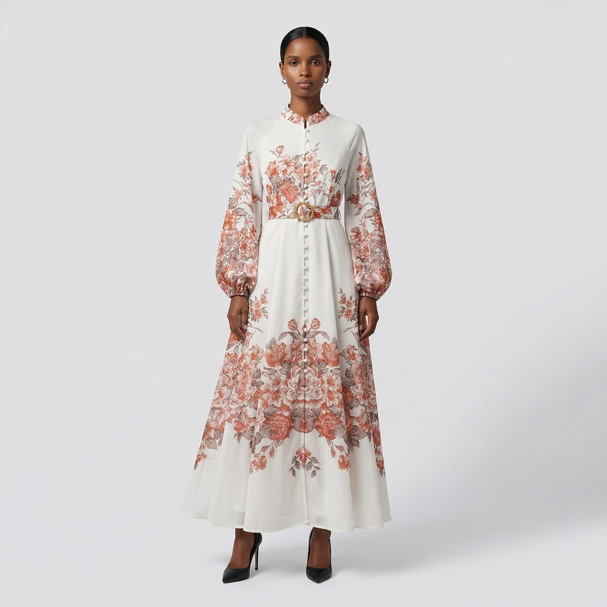The Heba maxi dress in a 141 cm length featuring a long-sleeved ribbed knit bodice and a dramatic side-pleated accordion skirt with a matching waist belt.