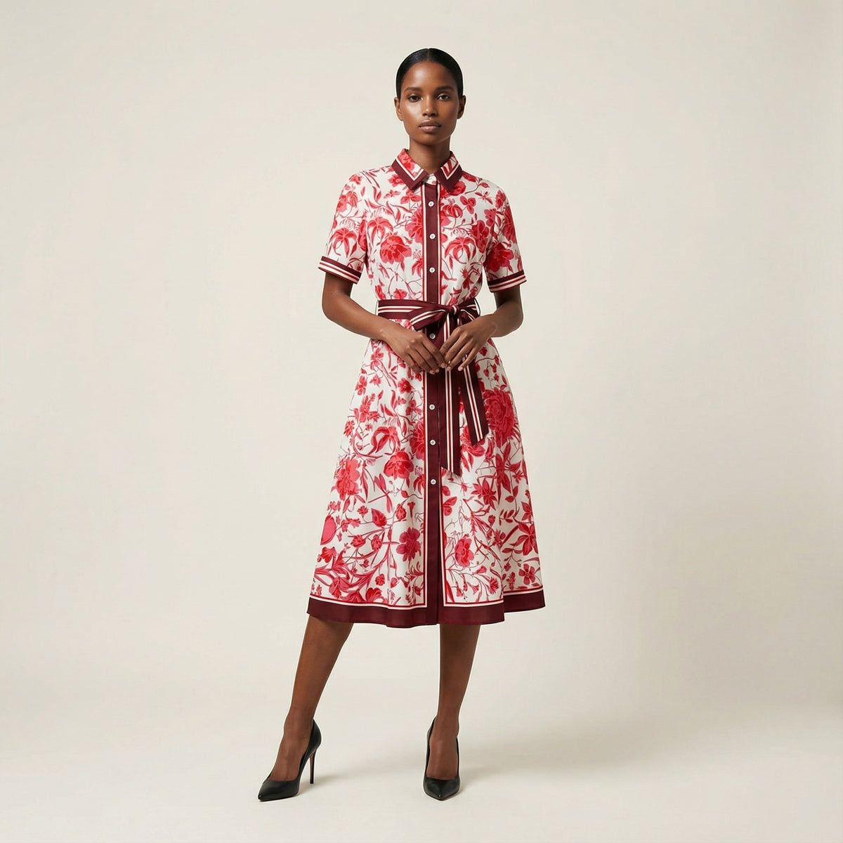 he Inese midi dress in a vibrant blue and red colorway, featuring a long-sleeved ribbed knit bodice and a side-pleated accordion skirt with a matching waist belt.
