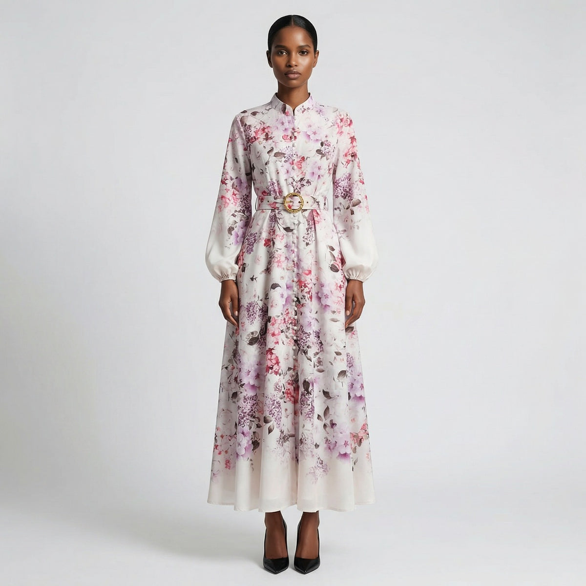 The Jana maxi dress in a 147 cm length featuring a long-sleeved ribbed knit bodice and a dramatic side-pleated accordion skirt with a matching waist belt.