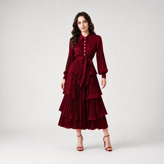 Julia Dress in burgundy, a long-sleeved pleated maxi dress with tiered ruffles and a waist tie.