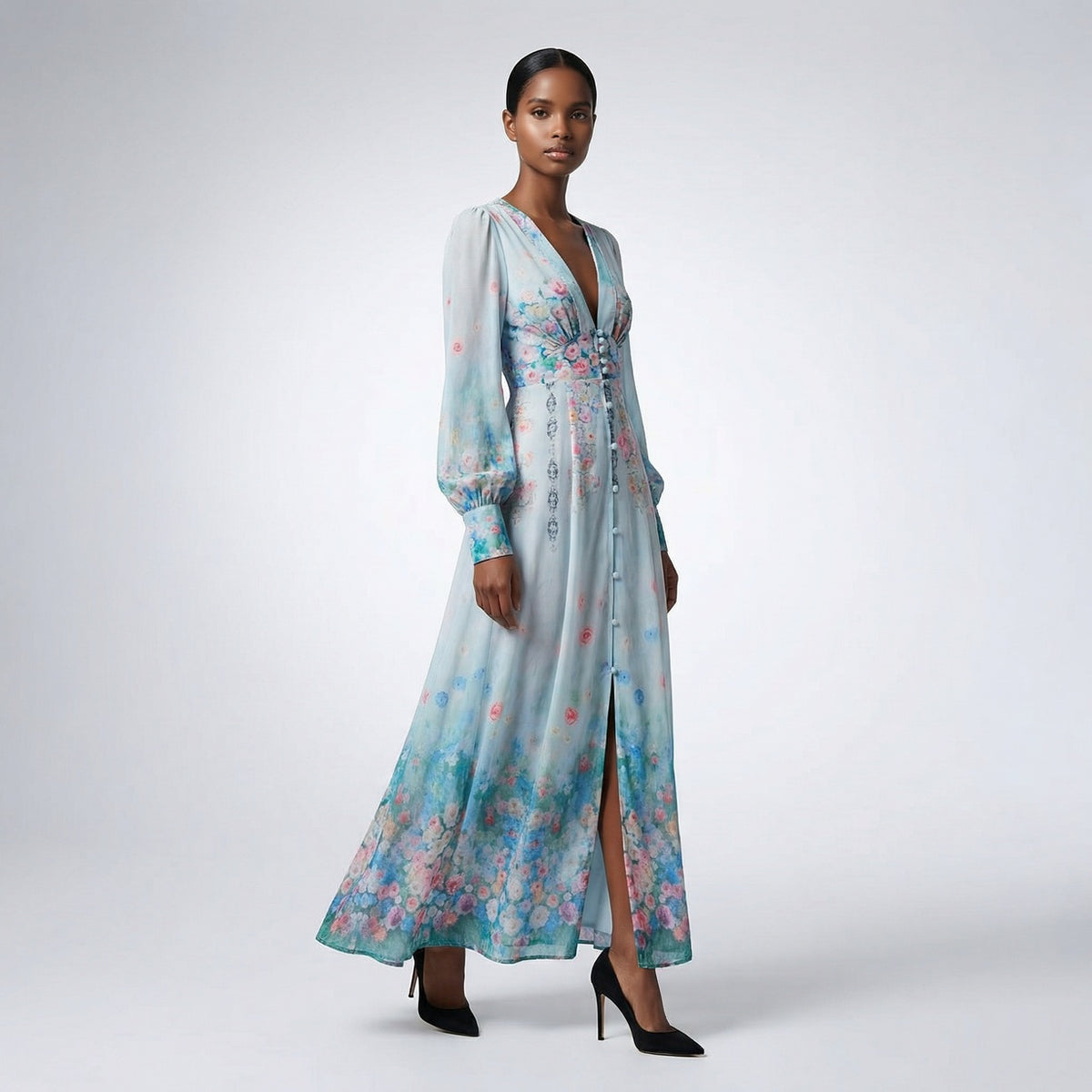 Front view of the Julie maxi dress in white featuring colorful floral and butterfly prints with a button-down front and V-neckline.