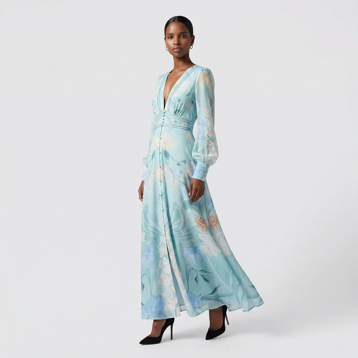 Front view of the Julie maxi dress in white featuring colorful floral and butterfly prints with a button-down front and V-neckline.