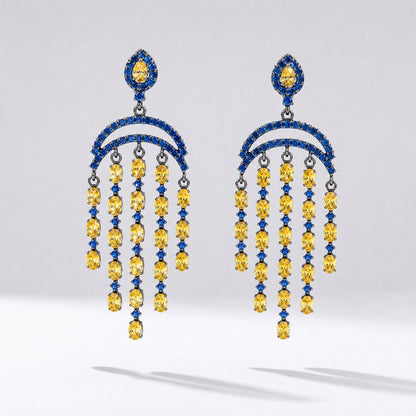 Pair of Leah geometric drop earrings featuring tiered blue and yellow cubic zirconia stones in a black gold setting.