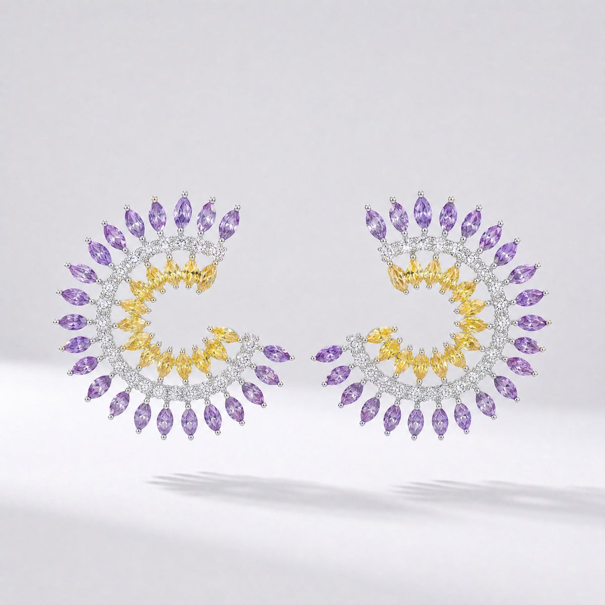 Pair of Leah spiral earrings in blue/green and purple/yellow color options featuring marquise cubic zirconia stones.
Leah earrings, spiral stud earrings, colorful cz earrings, marquise cut jewelry, statement studs, versatile formal earrings, cubic zirconia jewelry