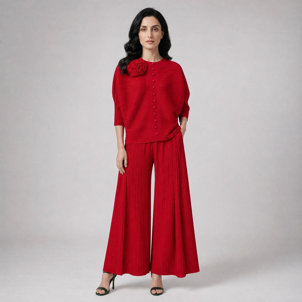 two-piece outfit featuring a button-up top with a 3D flower and wide-leg trousers.