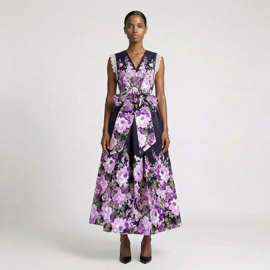 Lorelai floral print maxi dress in cream and purple featuring a v-neckline and large waist bow. Lorelai floral print maxi dress in black and purple with lace sleeve detailing and a full-length skirt.