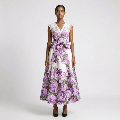 Lorelai floral print maxi dress in cream and purple featuring a v-neckline and large waist bow. Lorelai floral print maxi dress in black and purple with lace sleeve detailing and a full-length skirt.