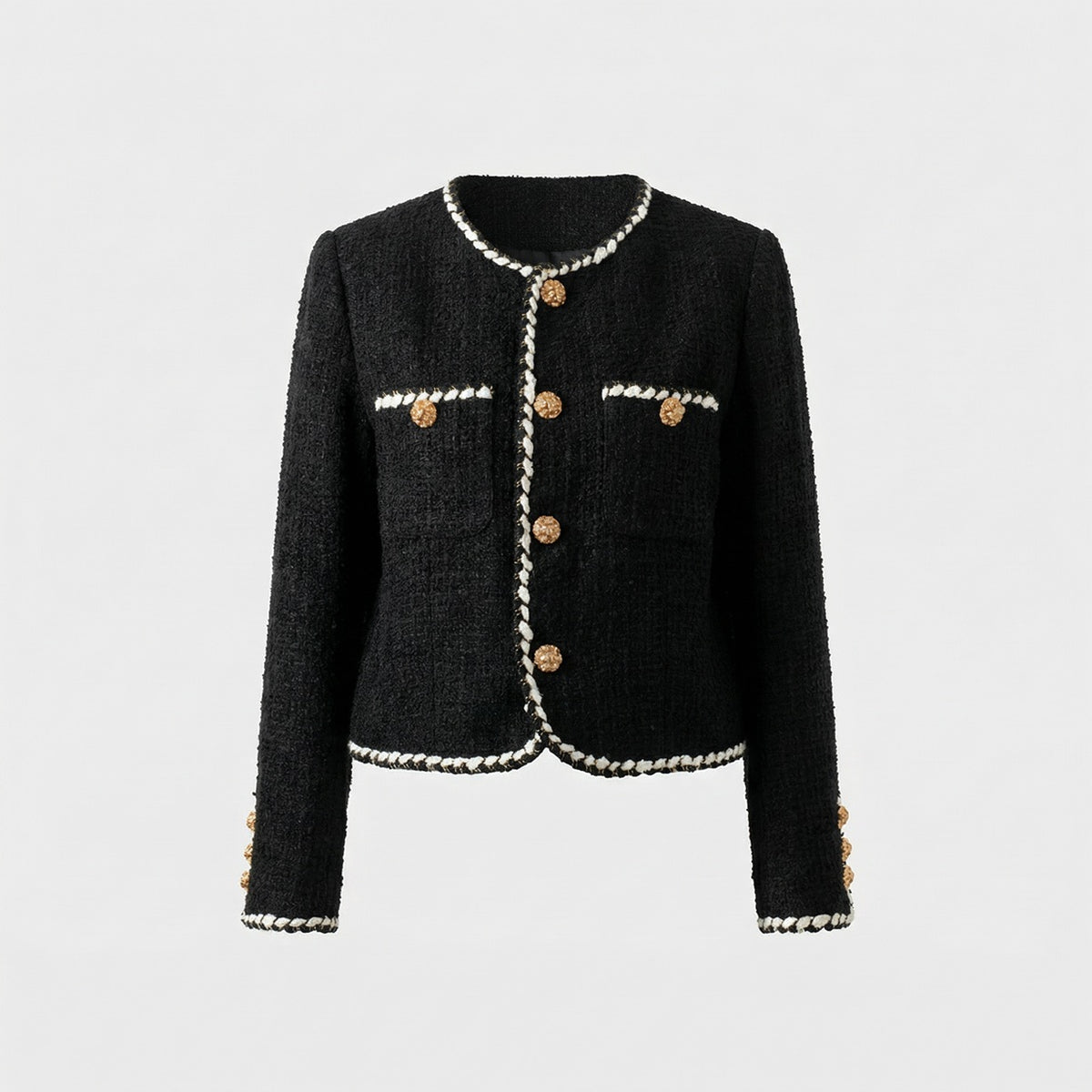 Flat lay of Louise black tweed jacket with white braided trim and gold floral buttons.