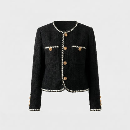 Flat lay of Louise black tweed jacket with white braided trim and gold floral buttons.