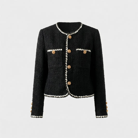 Flat lay of Louise black tweed jacket with white braided trim and gold floral buttons.