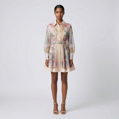 Front view of the Lumi Mini Dress featuring a pink rose and gold baroque print on white chiffon with a gold buckle belt.