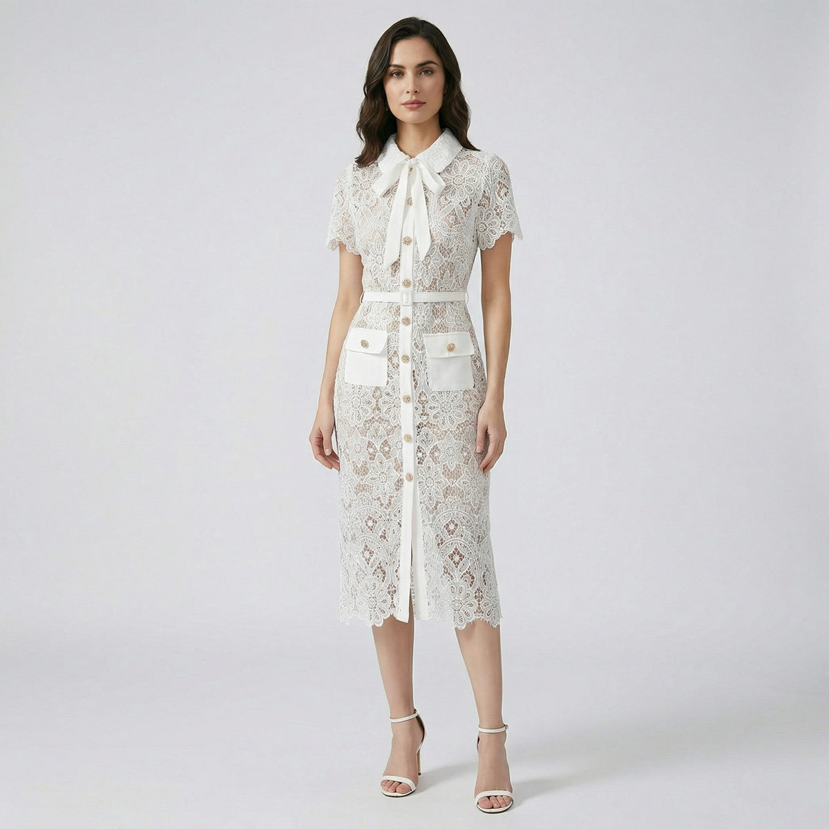 Front view of Lya white floral guipure lace midi shirt dress with gold buttons and bow collar.