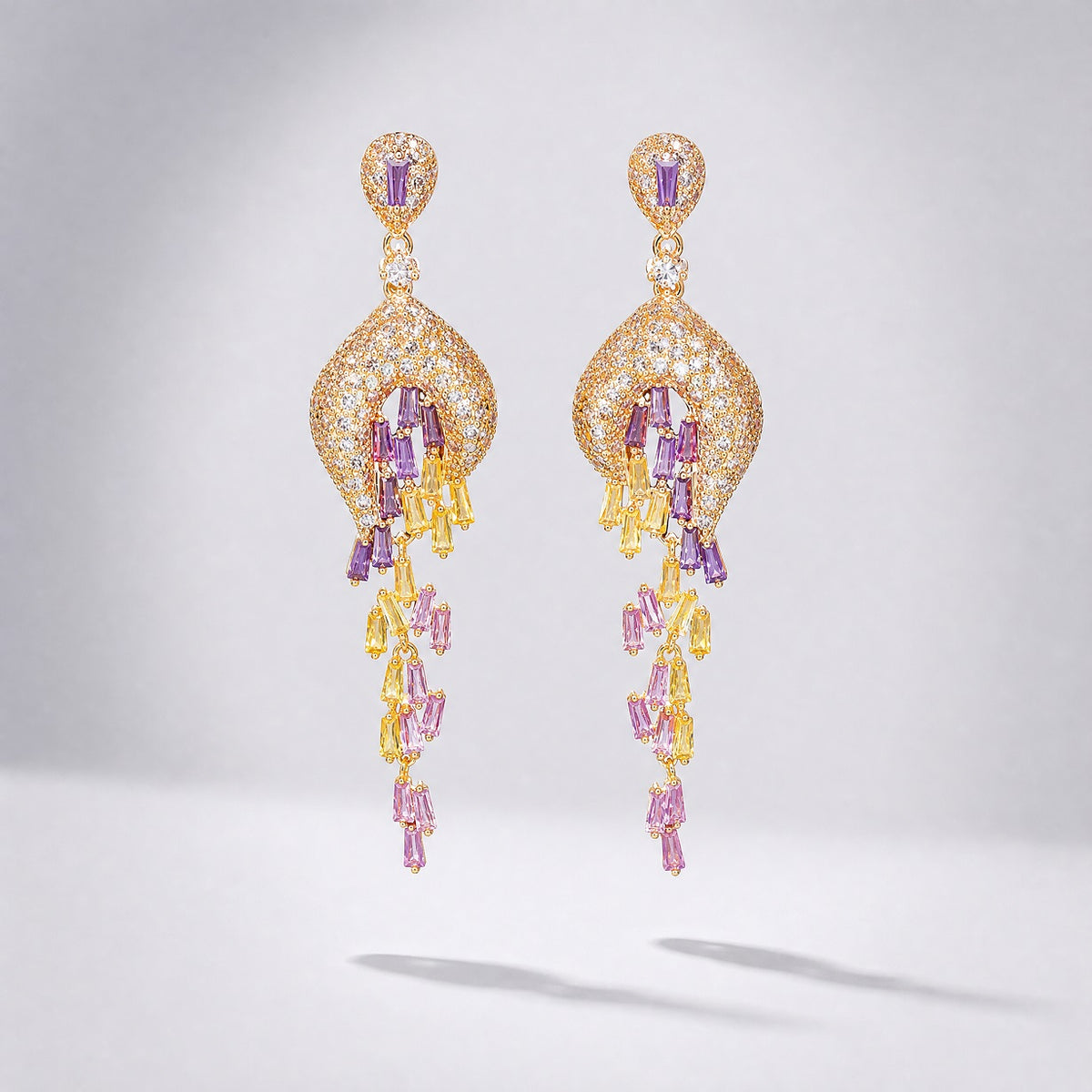 Lyana 7cm long tassel drop earrings with yellow, pink, and lilac baguette-cut cubic zirconia stones on yellow gold metal.