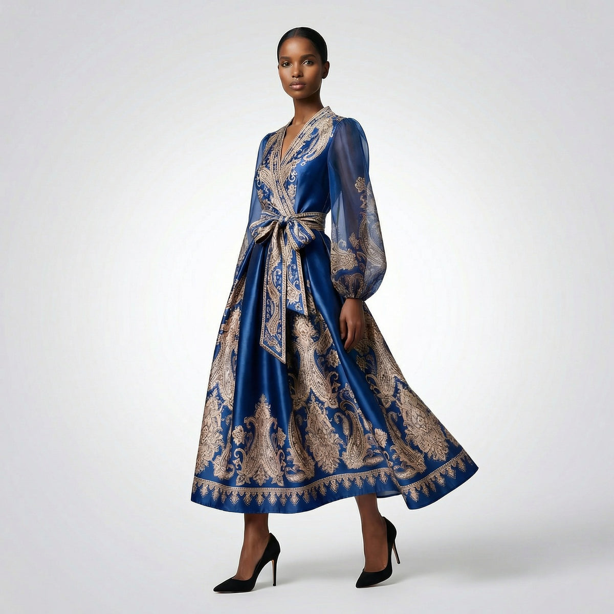Long-sleeved olive green paisley print maxi dress with a wrap waist and sheer sleeves laid flat.