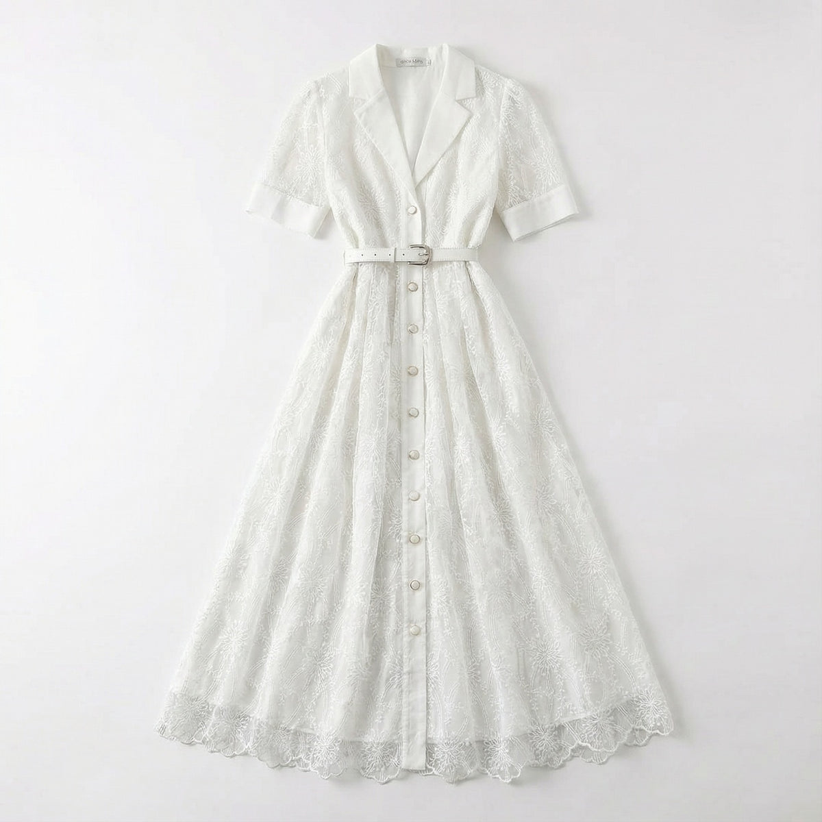 The Margaret dress featuring a long-sleeved ribbed knit bodice and a side-pleated accordion skirt with a matching waist belt in a 135 cm length.