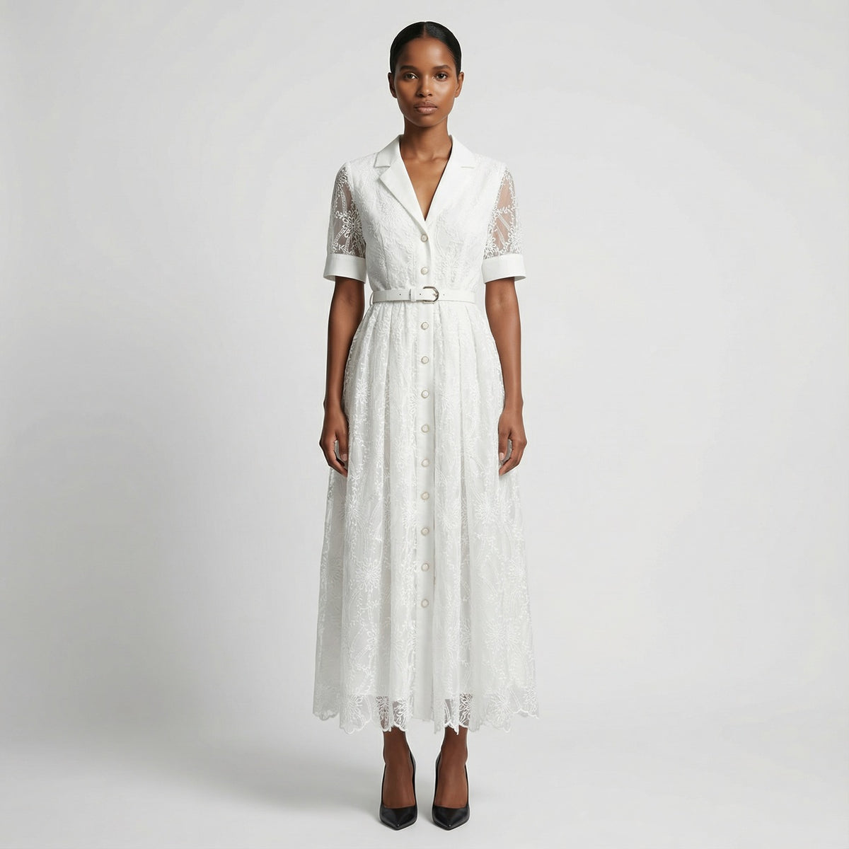 The Margaret dress featuring a long-sleeved ribbed knit bodice and a side-pleated accordion skirt with a matching waist belt in a 135 cm length.