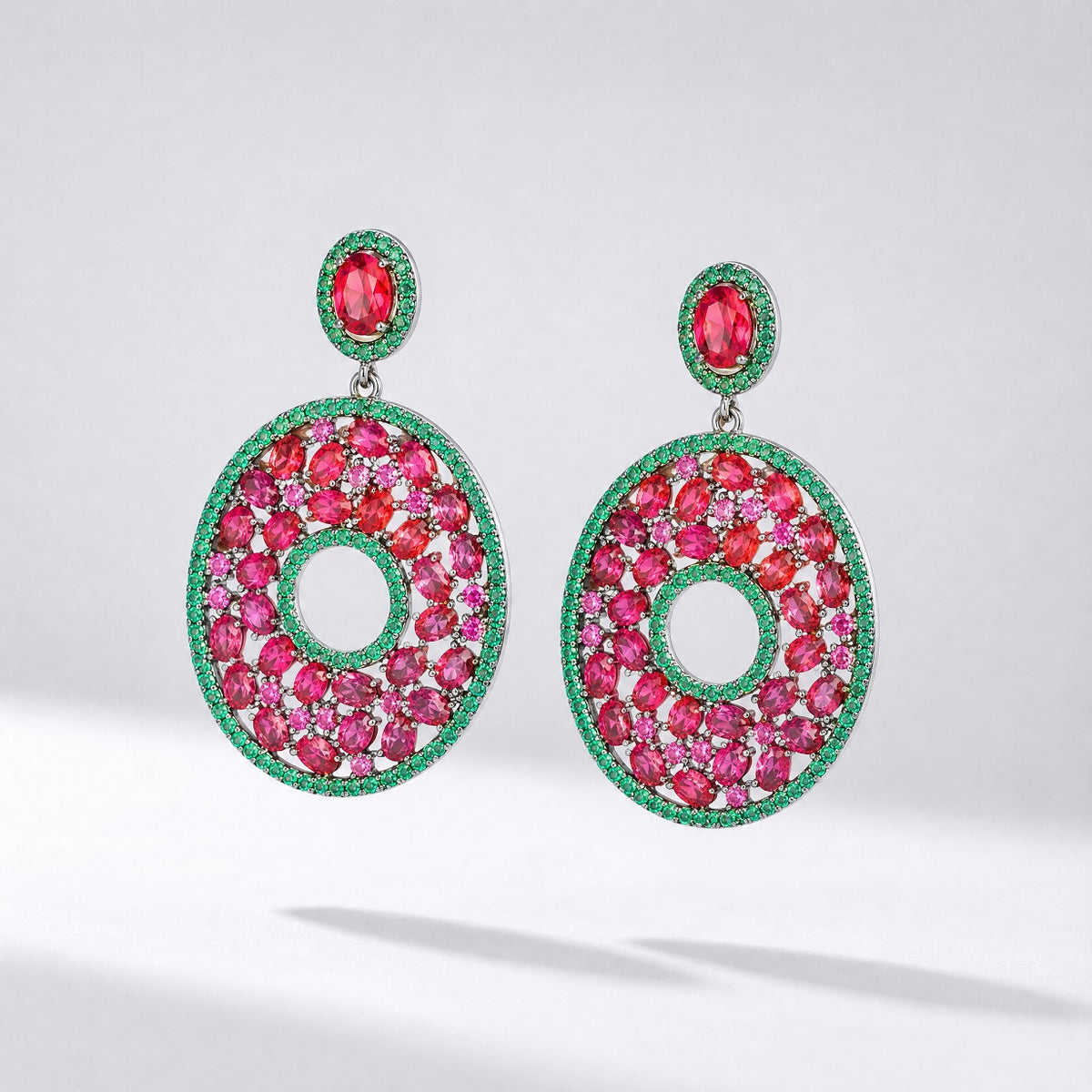 marie statement earrings featuring red and green cubic zirconia stones in a round open-hoop design