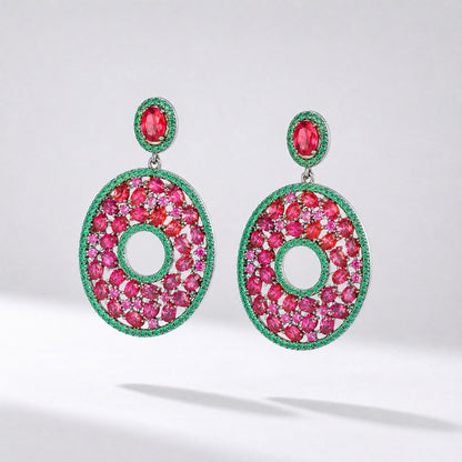 marie statement earrings featuring red and green cubic zirconia stones in a round open-hoop design