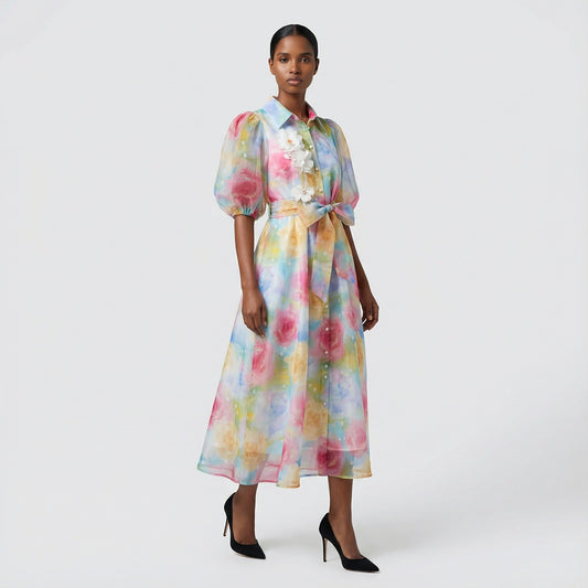 The Marie maxi dress in a 145 cm length featuring a long-sleeved ribbed knit bodice and a dramatic side-pleated accordion skirt with a matching waist belt.