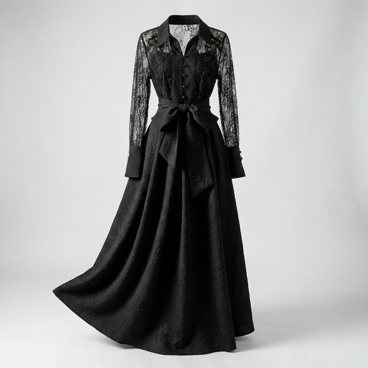 Full-length view of Monika 140cm maxi dress featuring sheer lace sleeves and textured wood-grain jacquard fabric in black and cream.