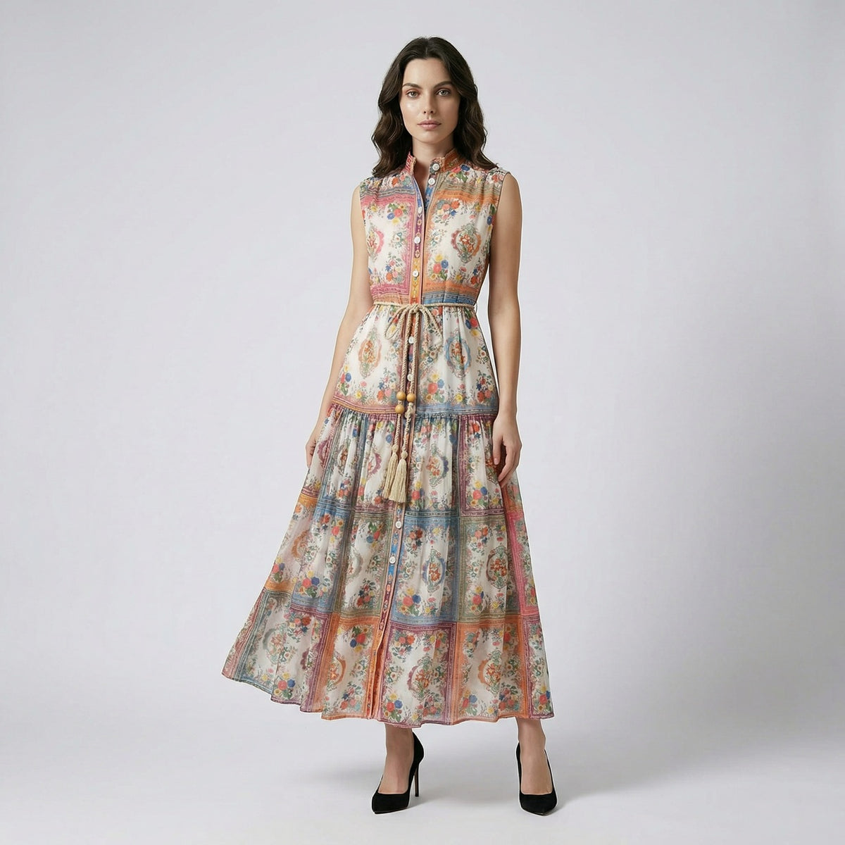 Full length view of the Nichole sleeveless maxi dress featuring a vibrant patchwork floral print and a rope tassel waist belt.