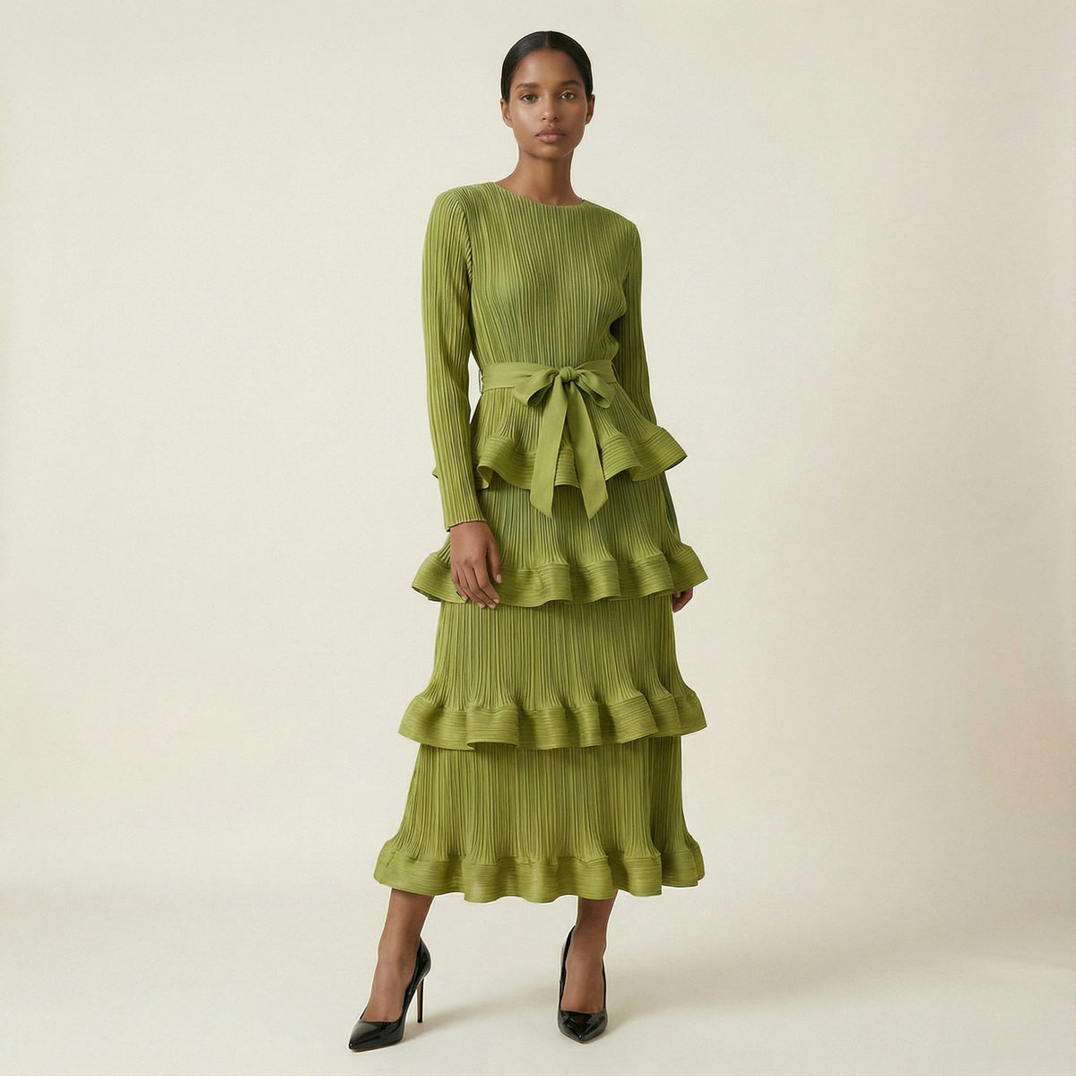 A woman modeling the Olivera long-sleeved green ribbed knit dress.