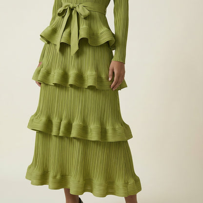 A woman modeling the Olivera long-sleeved blue ribbed knit dress.
