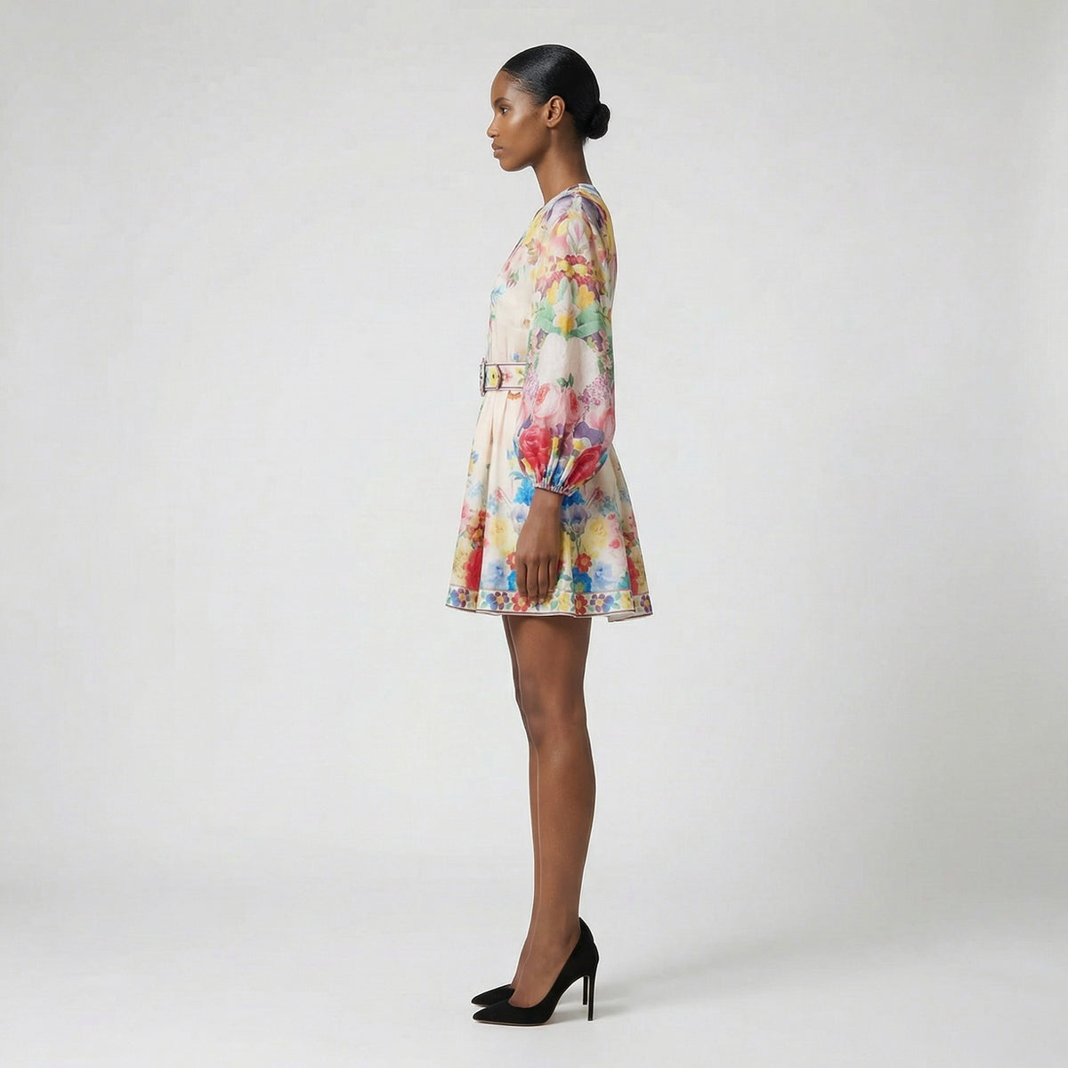 The Rebecca mini dress shown in blue and white featuring a long-sleeved ribbed knit bodice and a dramatic side-pleated accordion skirt with a matching waist belt.