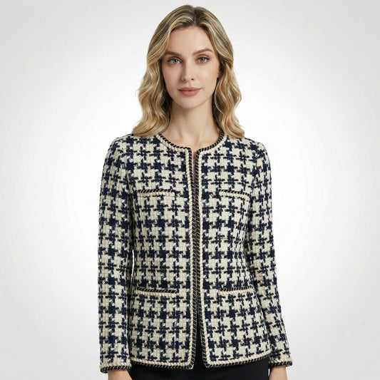 Close-up of Selina navy and cream houndstooth tweed jacket featuring gold braided trim and four front pockets.