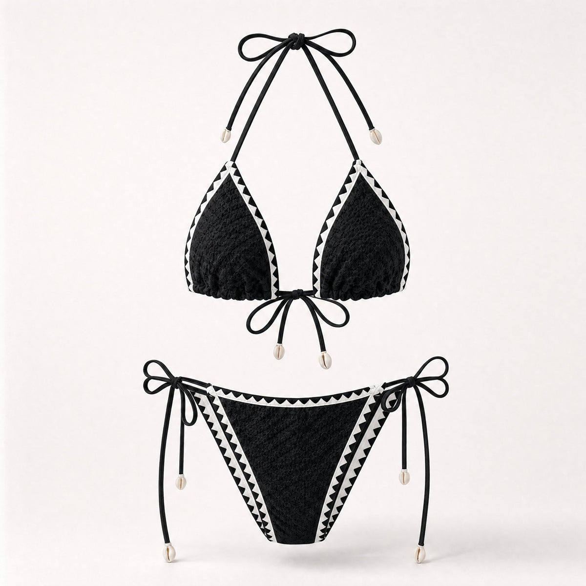 Classic black textured bikini with white zig-zag trim and shells.