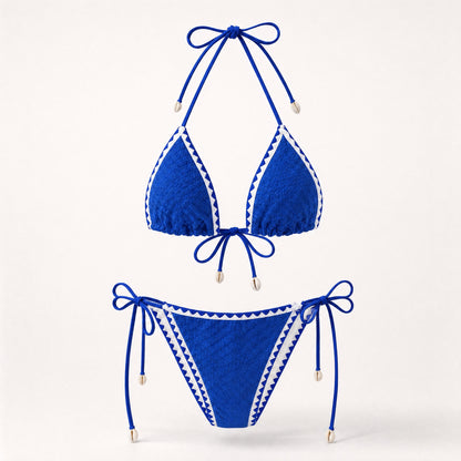 Royal blue textured triangle bikini with shell charms and white zig-zag trim.