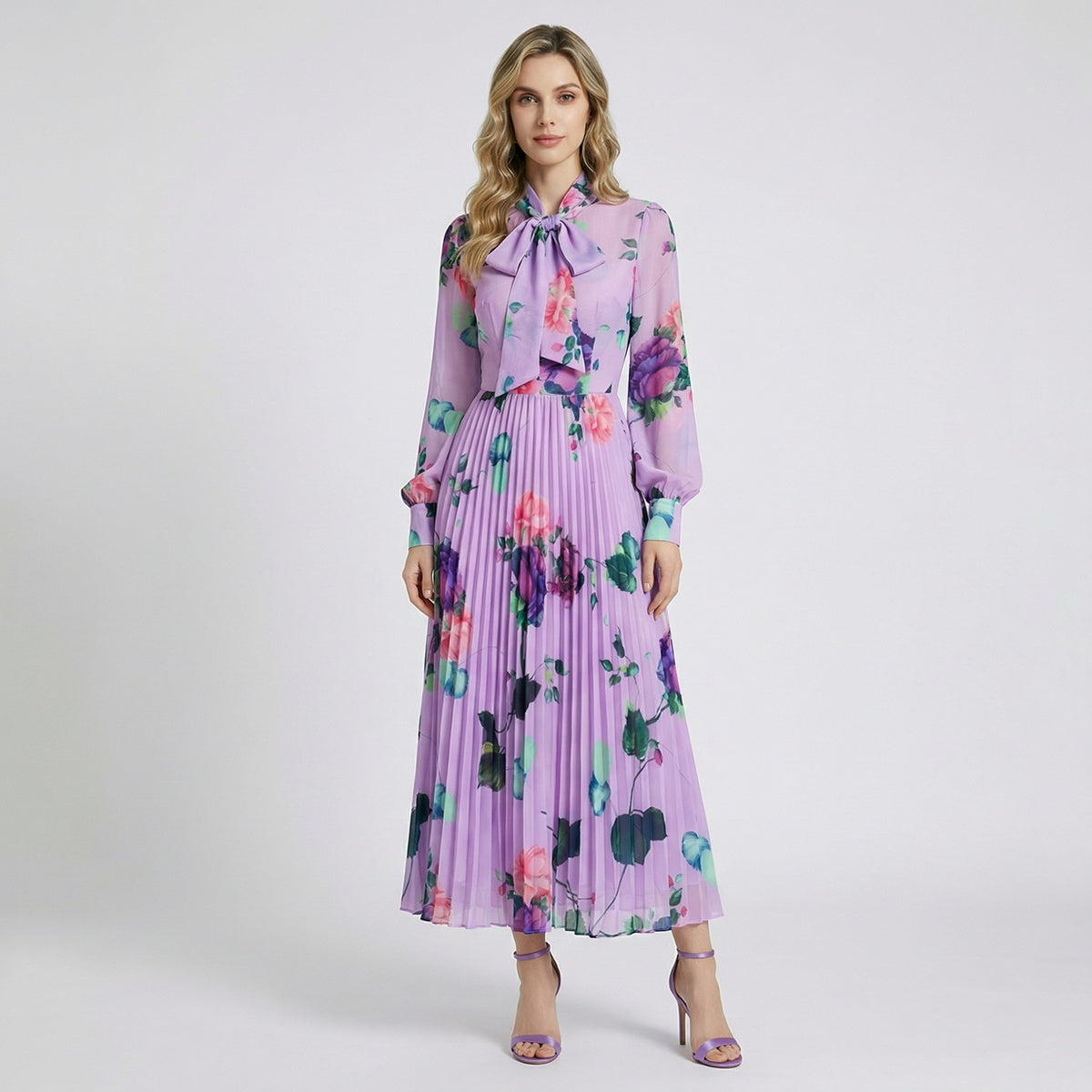 Full-length view of the Sonia lavender floral pleated maxi dress with pussy-bow neckline and long sheer sleeves.