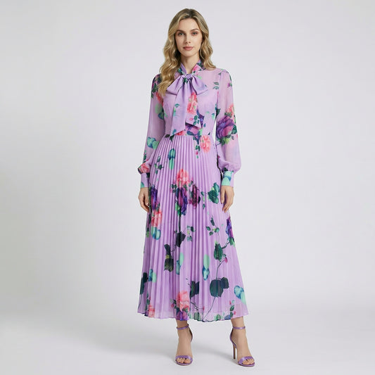 Full-length view of the Sonia lavender floral pleated maxi dress with pussy-bow neckline and long sheer sleeves.