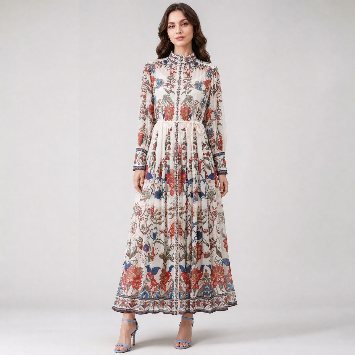 Veronika dress in white chiffon with purple and orange floral print, featuring a belted waist and long sleeves. chiffon gown in a vibrant purple and orange garden floral design.