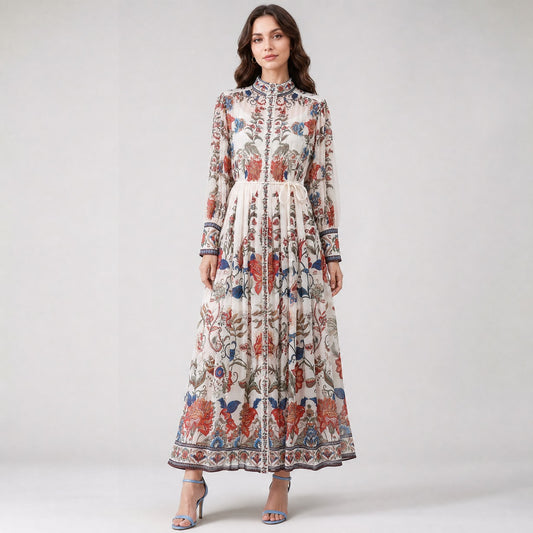 Veronika dress in white chiffon with purple and orange floral print, featuring a belted waist and long sleeves. chiffon gown in a vibrant purple and orange garden floral design.