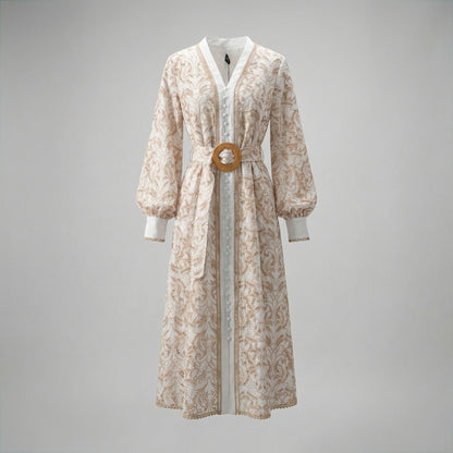 Tamara boho midi dress featuring white lace with tan embroidery, lantern sleeves, and a circular straw belt buckle.